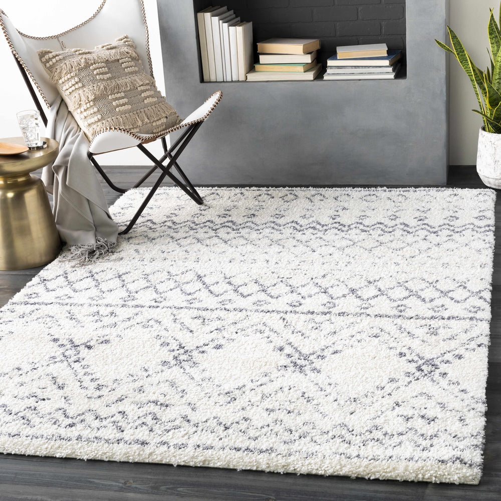 Modern ivory and blue-gray geometric area rug with diamond and chevron pattern