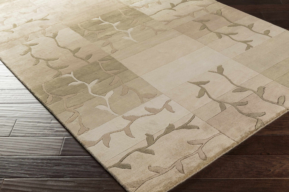 Tan hand-knotted area carpet with vine motif patchwork design