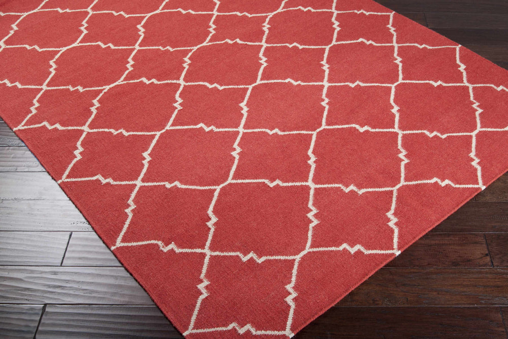 Red area rug with white trellis lattice pattern, corner shown on floor