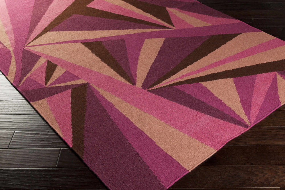 Pink geometric wool area rug with starburst rays and layered stripes in tan, purple, and brown