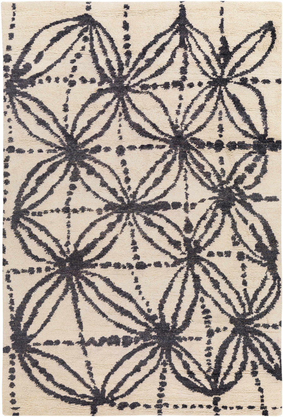 Beige area rug with charcoal starburst floral and dot geometric pattern, rectangle