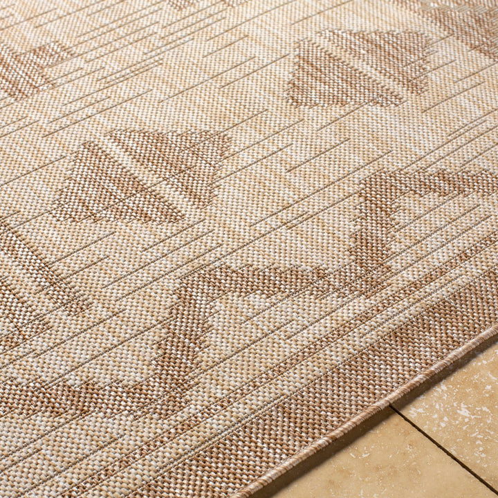 Beige modern area rug close-up with textured geometric stripes and motifs