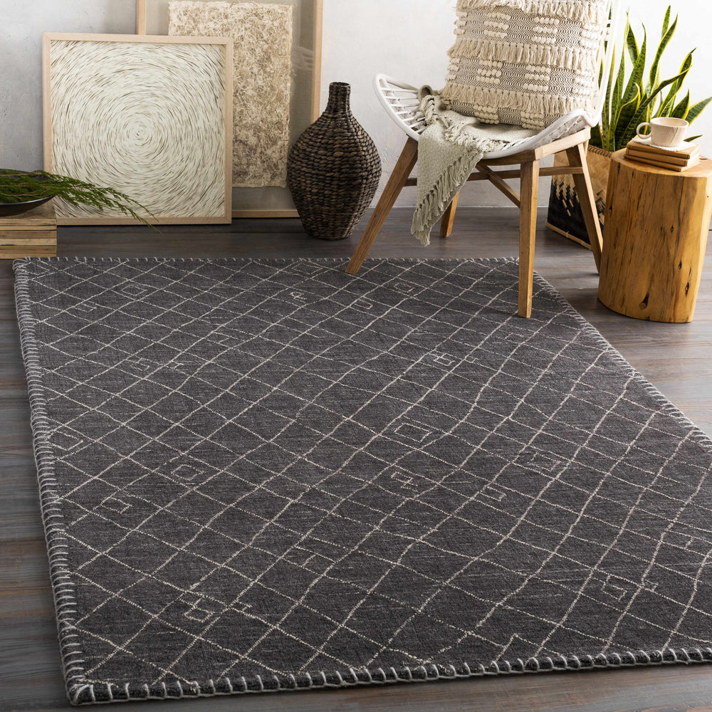 Charcoal geometric area rug with light line pattern and short fringe trim