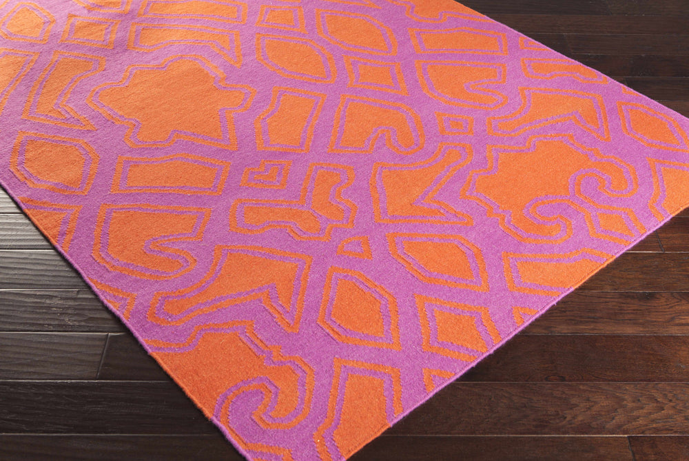 Purple and orange hand-woven wool area rug with bold geometric pattern, angled view