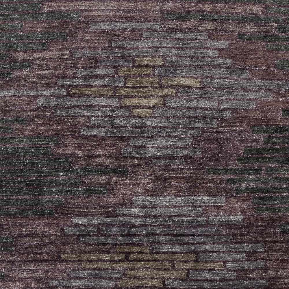 Abstract rug close-up: charcoal base with purple and muted gold-gray block lines.