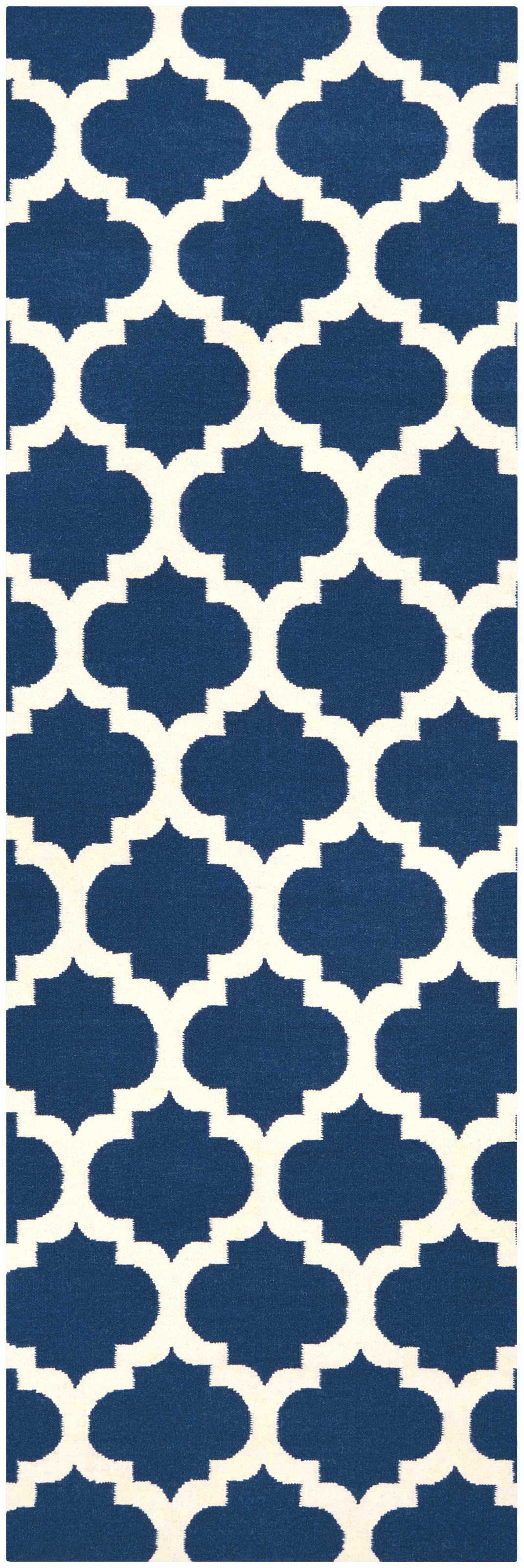Rectangular wool rug showing repeating blue-and-ivory quatrefoil pattern