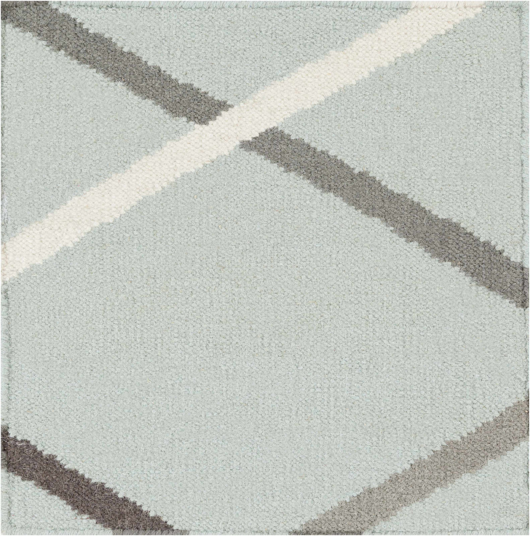Wool rug close-up with light gray pile and taupe crosshatch bands