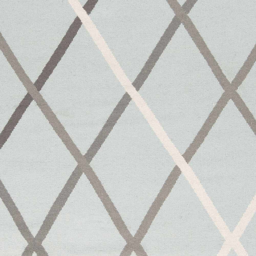 Close-up of light gray hand-woven wool rug with white and taupe diamond lattice