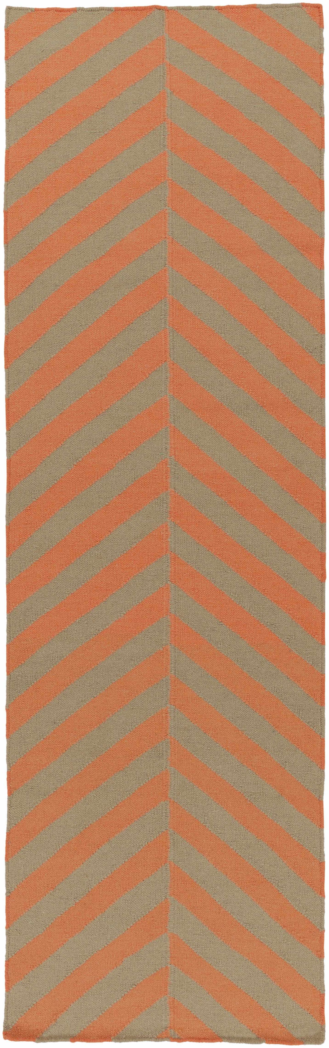 Hand-woven area rug with orange and brown chevron zigzags on cream background