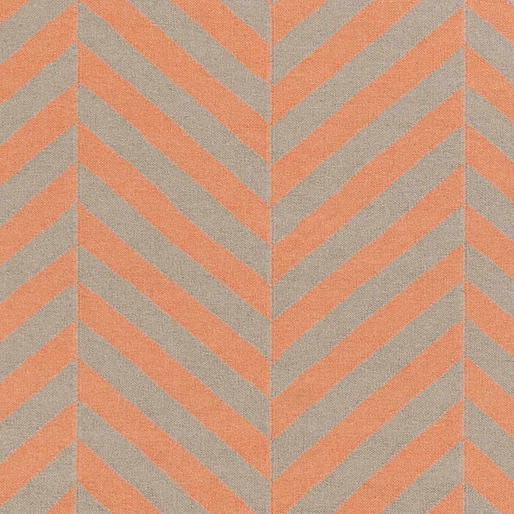 Hand-woven area rug close-up with orange chevron stripes on cream ground