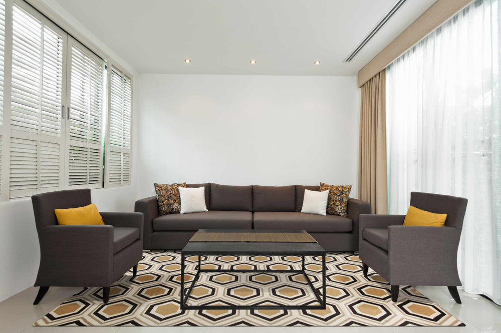 Geometric area rug in beige and black with repeating hexagon motif