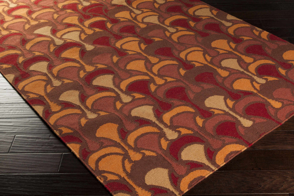 Brown, orange, and red area rug corner with curved arch motifs