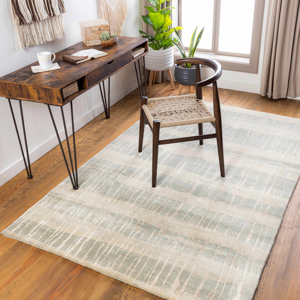Rectangular hand-knotted rug in light blue and beige with textured grid weave.