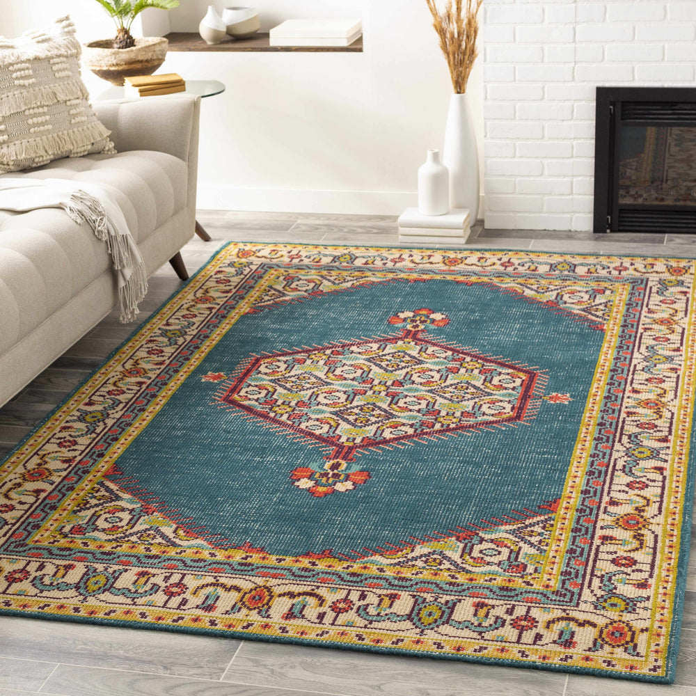 Traditional hand-knotted area rug with teal center, beige border, and colorful motif