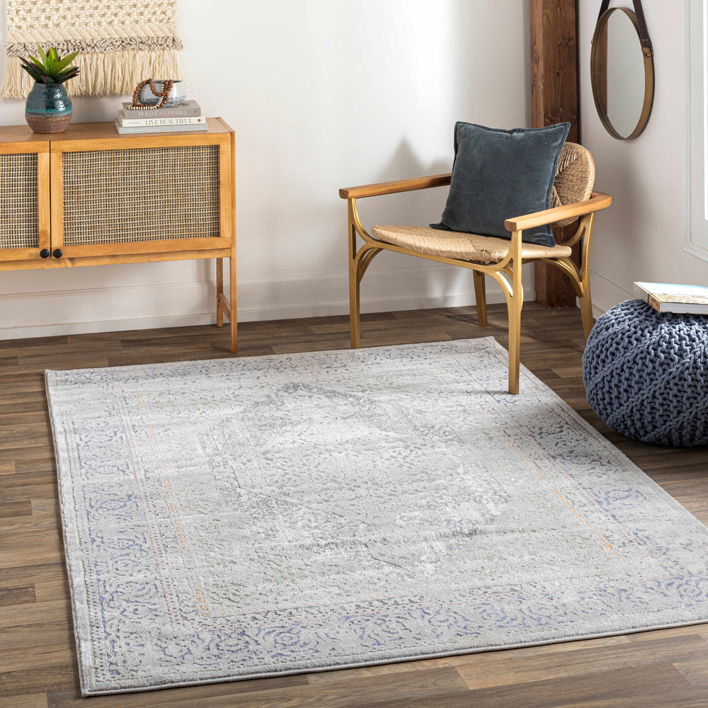 Traditional ivory and blue area rug with distressed pattern and decorative border