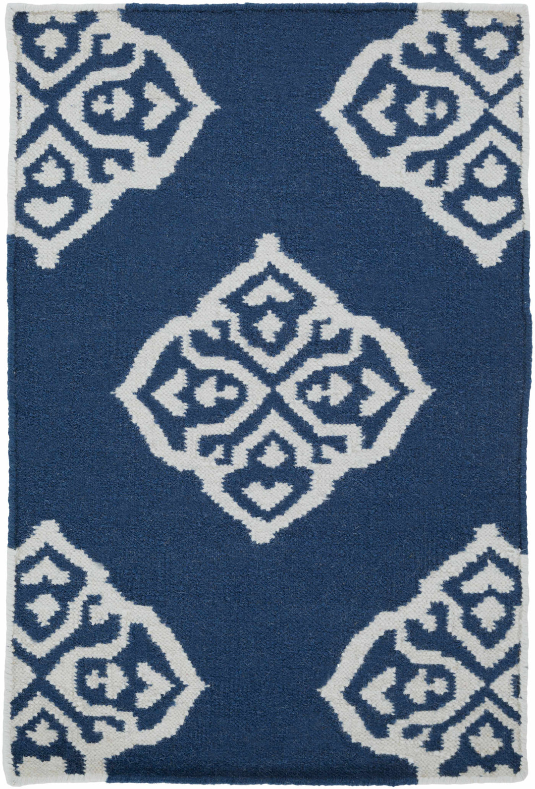 Blue rug with centered ivory diamond motif and surrounding geometric diamonds
