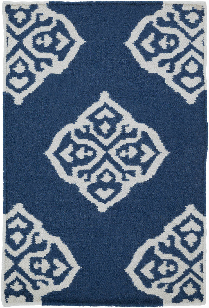 Blue rug with centered ivory diamond motif and surrounding geometric diamonds