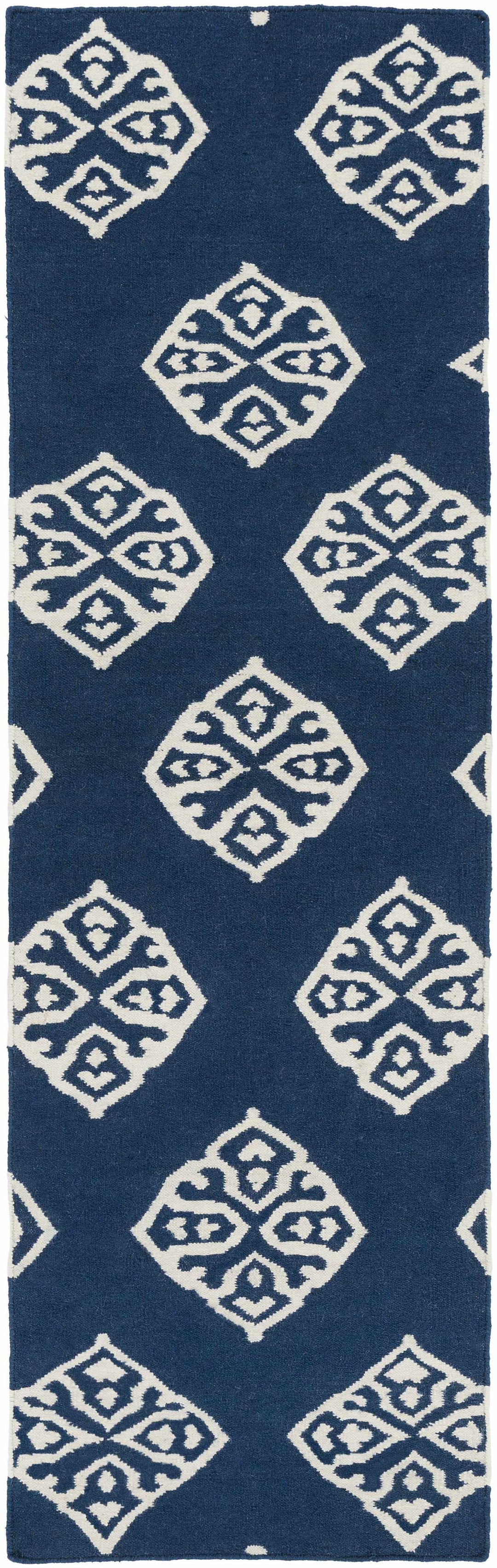 Blue area rug with scattered ivory diamond medallion pattern, vertical crop