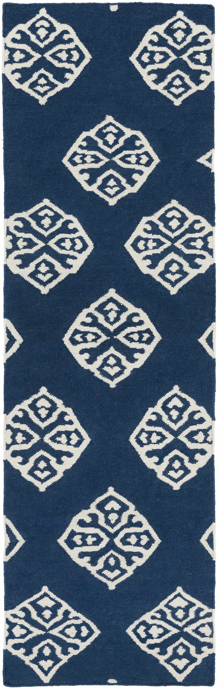 Blue area rug with scattered ivory diamond medallion pattern, vertical crop
