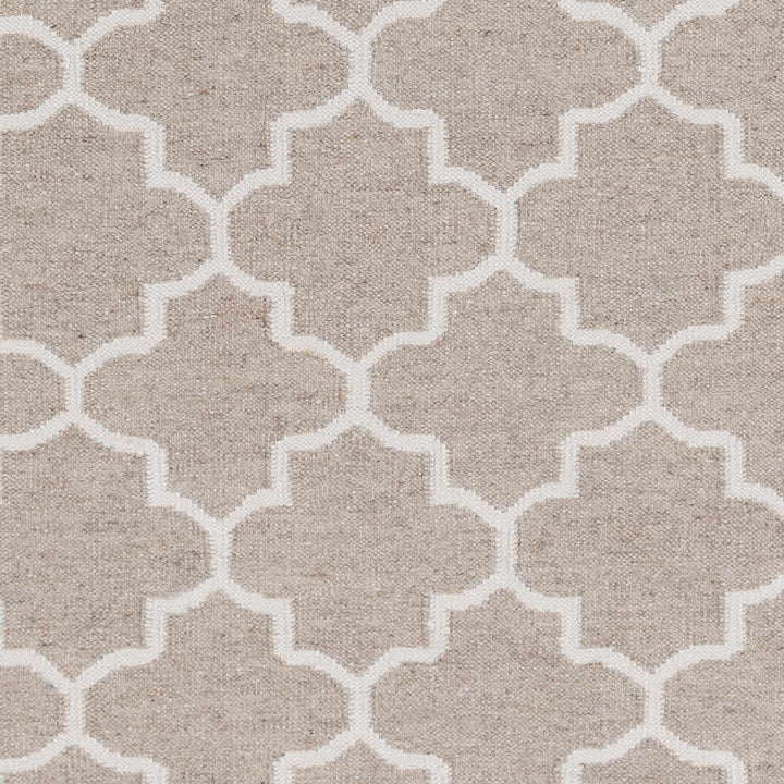 Close-up of beige fabric with ivory four-lobed trellis geometric pattern