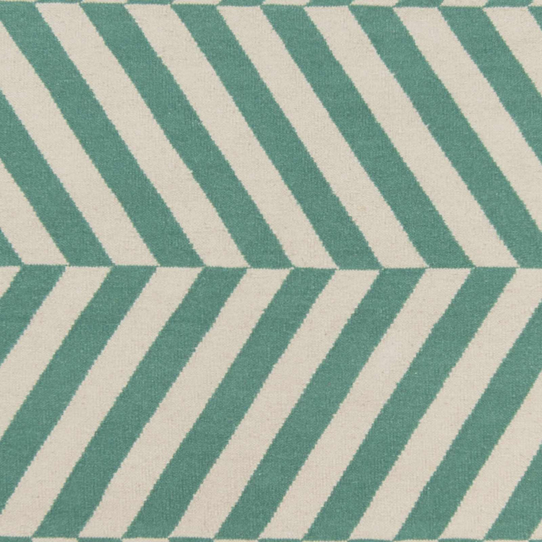 Close-up of green and ivory chevron rug pattern with woven texture.