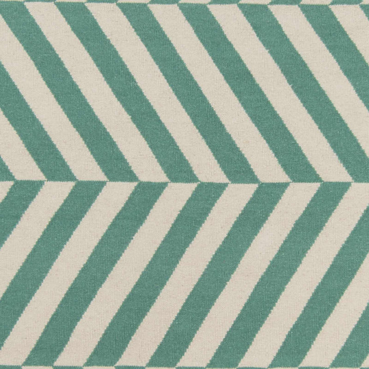 Close-up of green and ivory chevron rug pattern with woven texture.