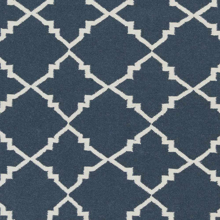 Close-up of blue and ivory geometric trellis pattern on area rug