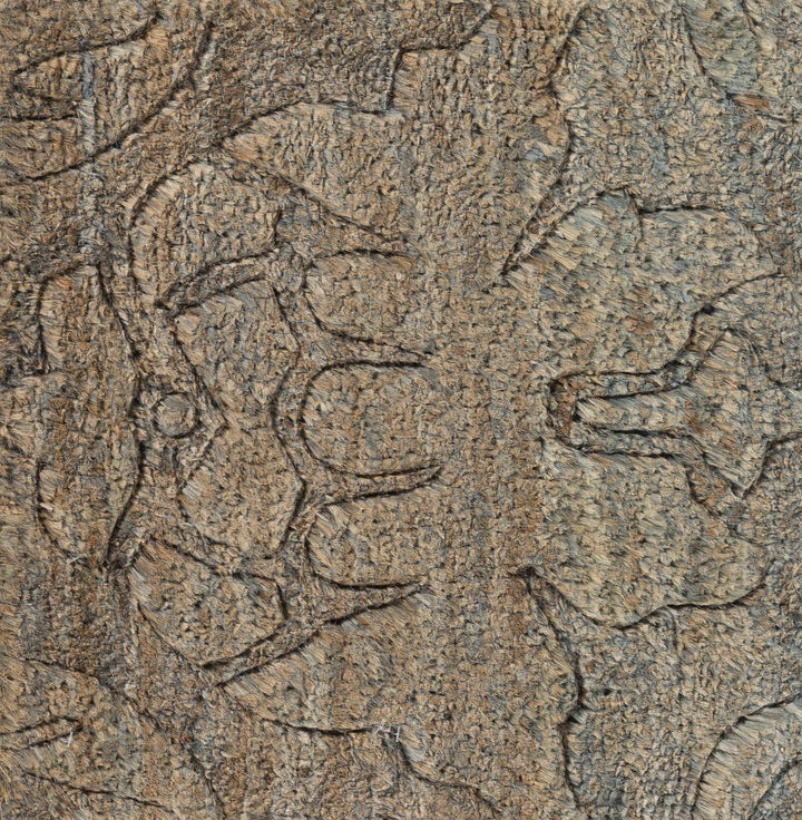 Close-up detail of brown jute rug texture with abstract hand-knotted lines