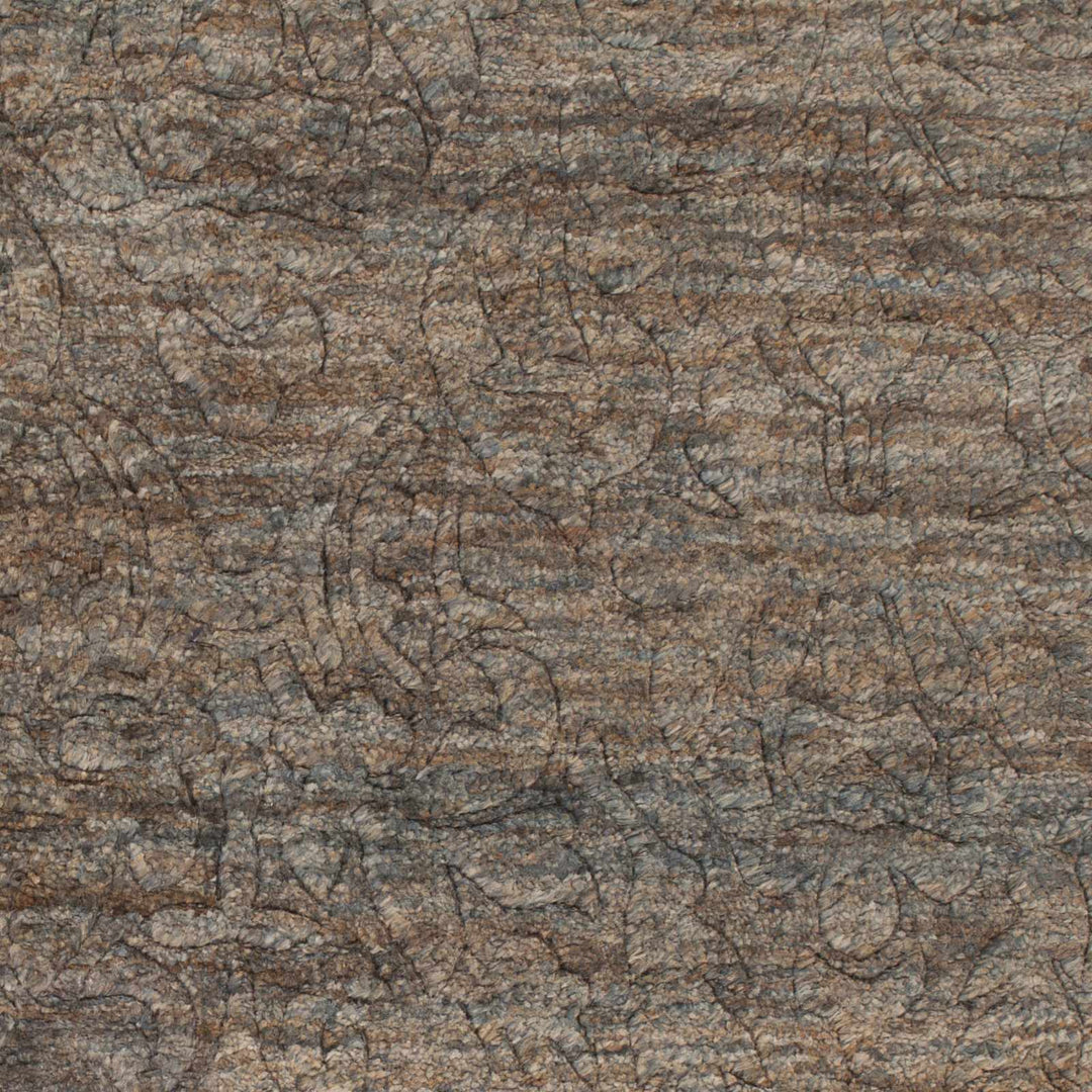Close-up of brown jute rug showing abstract hand-knotted texture and lines