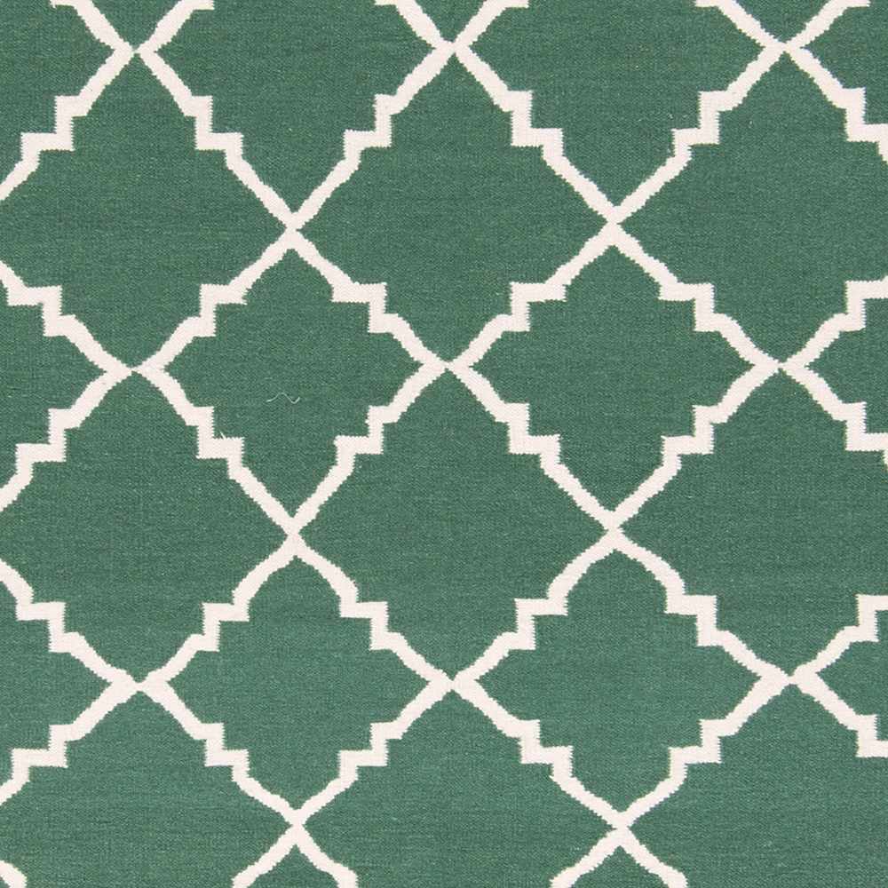 Hand-woven green area rug close-up of white geometric lattice pattern
