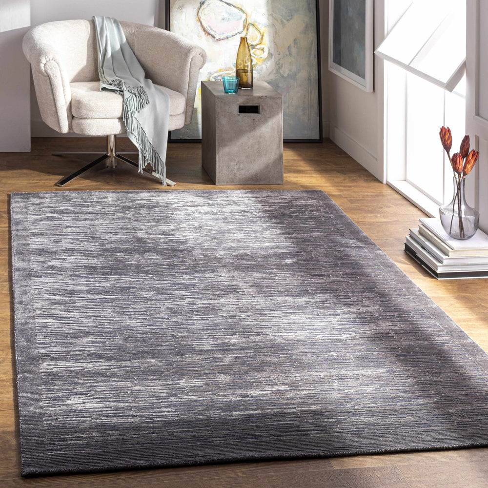 Charcoal gray textured area rug laid flat with subtle linear pattern.