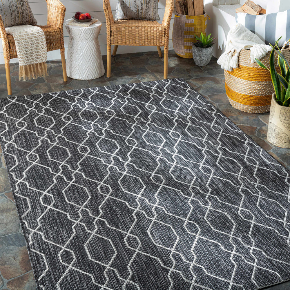Outdoor area rug with charcoal base and ivory lattice geometric pattern in rectangle view