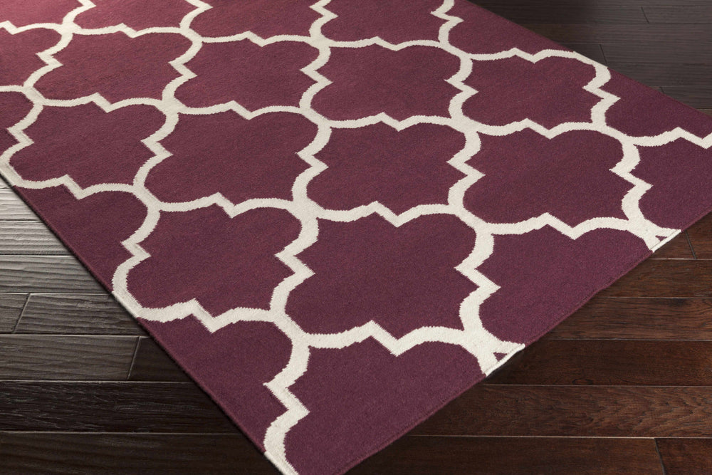 Hand-woven purple area rug, off-white trellis geometric pattern on corner
