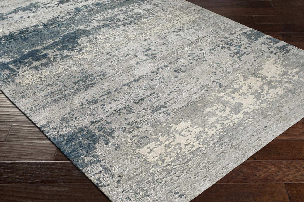 Modern abstract hand-knotted area rug, light gray field with teal-blue distressed blocks