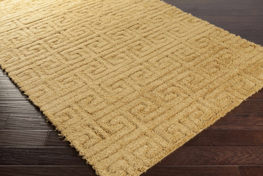 Mustard geometric wool area rug, angled view showing textured surface and border.