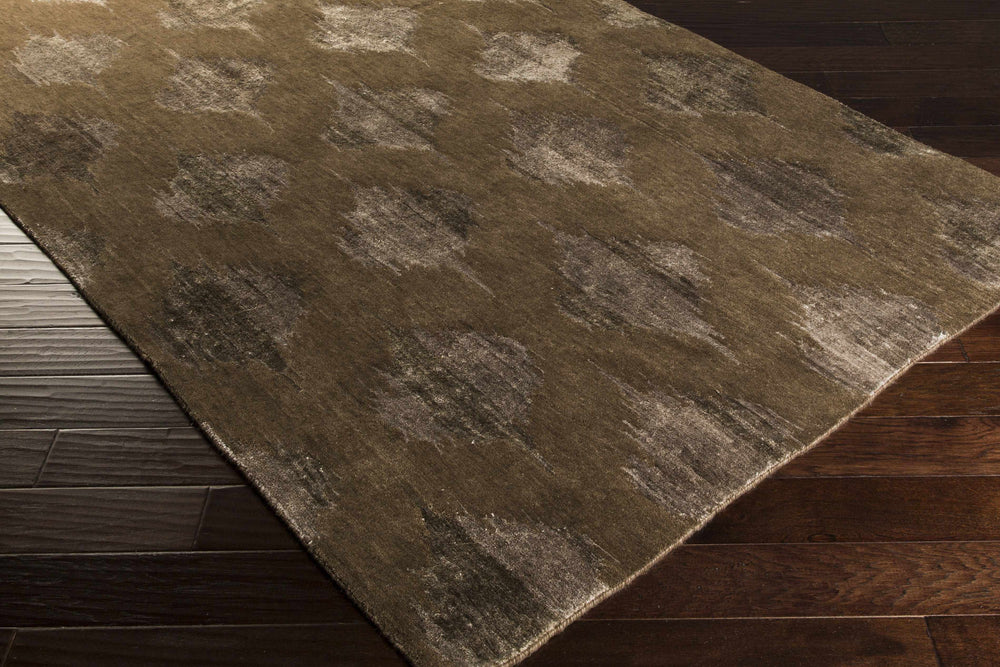 Hand-knotted wool area rug, brown and ivory abstract diamond pattern, angled view