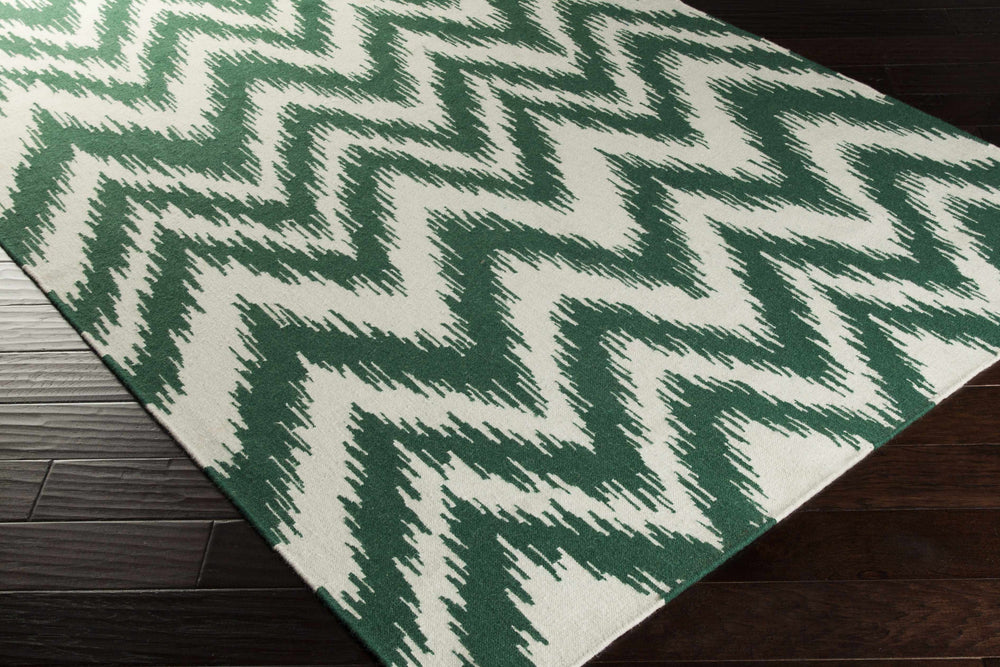 Green and white chevron-pattern hand-woven area rug shown at an angle, woven texture