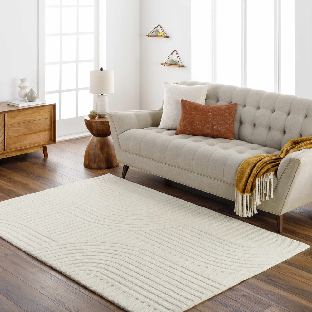 Beige hand-tufted wool area rug with textured geometric stripes, shown in living room