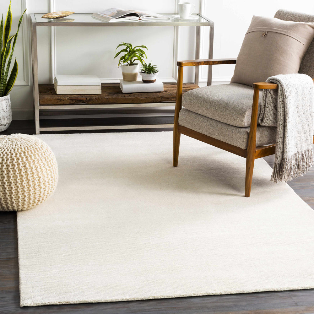 Ivory solid hand-knotted area rug with subtle linear weave texture