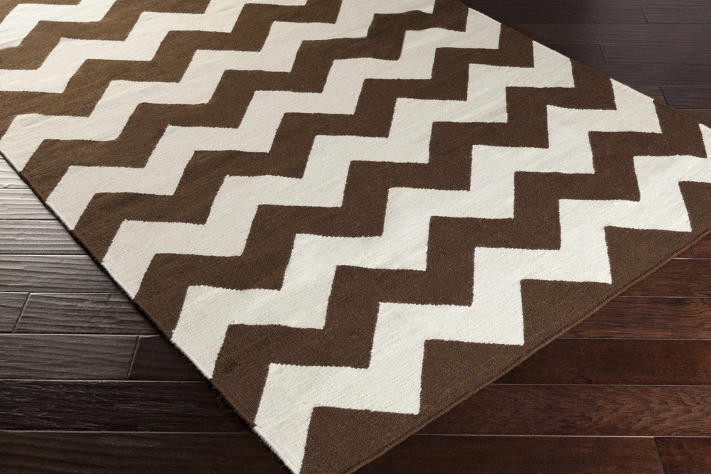 Rectangular chevron area rug with brown and ivory zigzag design and woven texture
