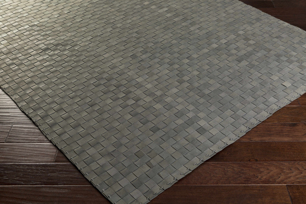 Gray hand-woven rug with woven square pattern, angled corner view