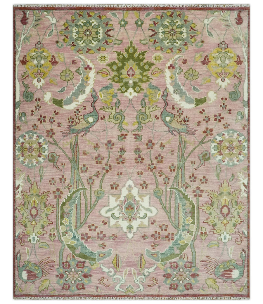 Pink and green hand-knotted wool rug with symmetrical peacock garden medallion design