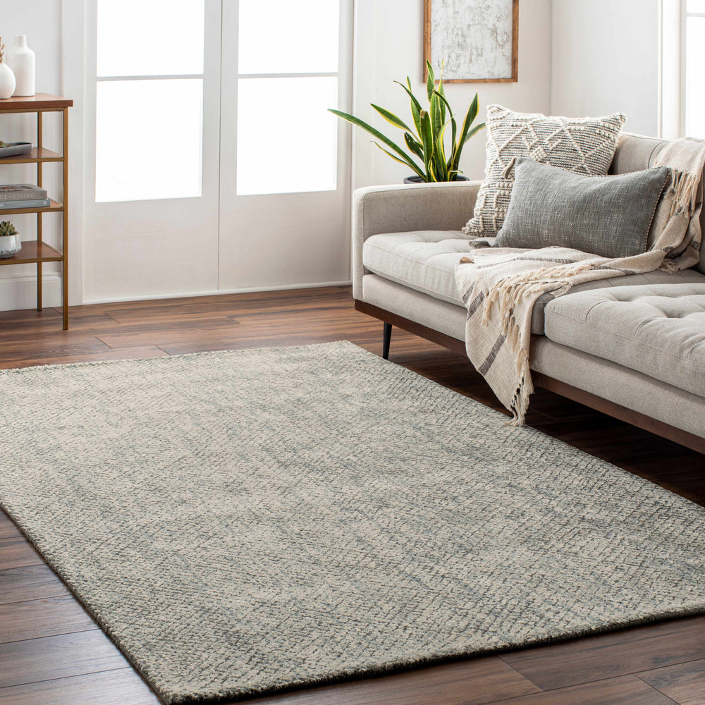 Beige and blue abstract area rug with speckled, low-pile texture