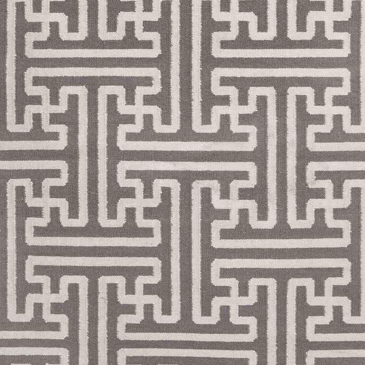 Gray and ivory Greek-key rug, tight close-up of repeating pattern and stripes