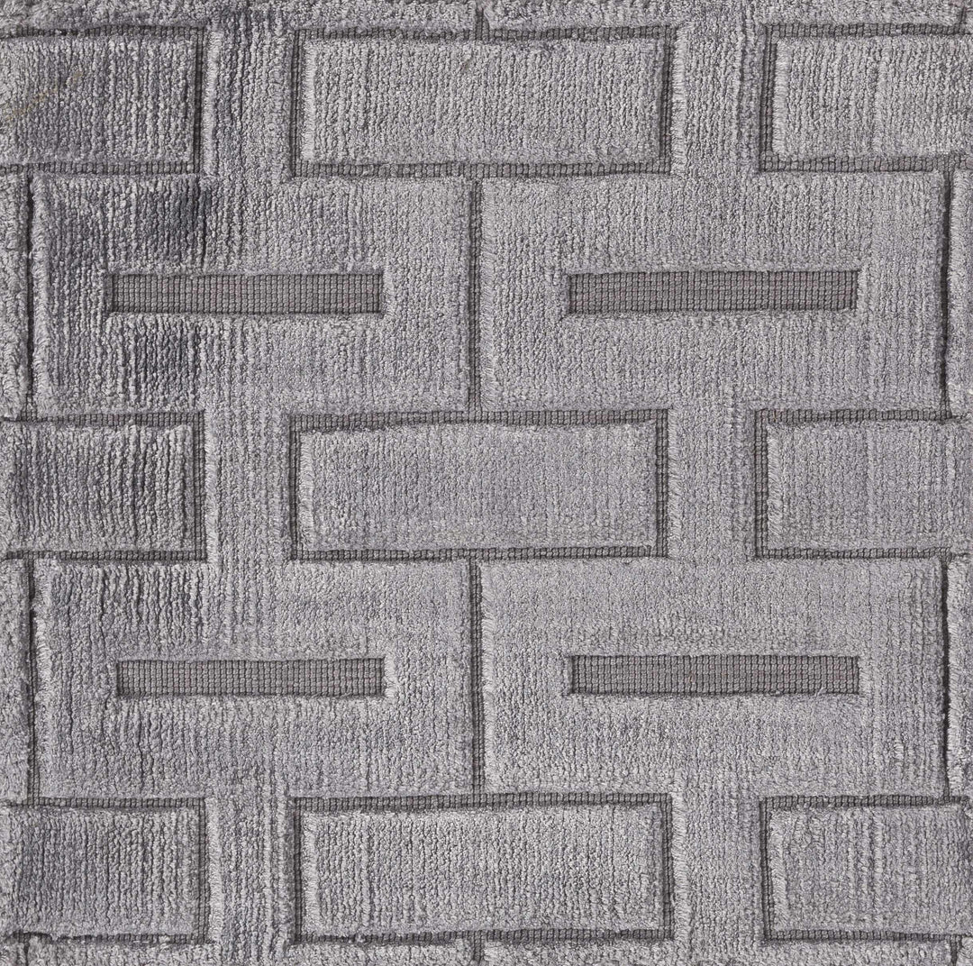 Close-up of gray and silver geometric rug texture with raised brick-like shapes