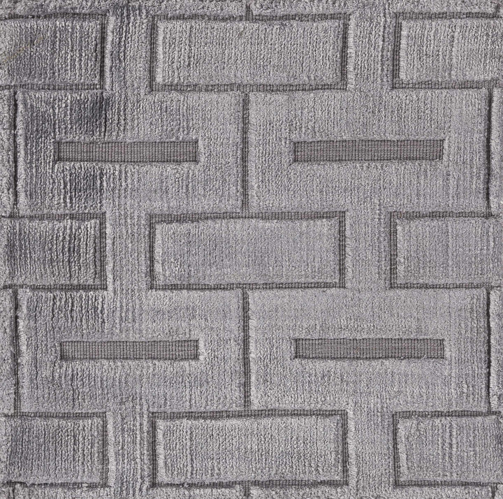 Close-up of gray and silver geometric rug texture with raised brick-like shapes