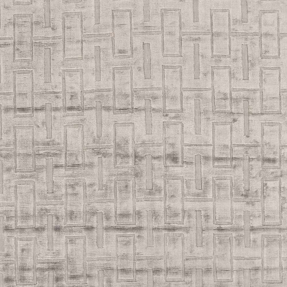 Close-up of light gray and silver geometric rug pattern with raised rectangular blocks