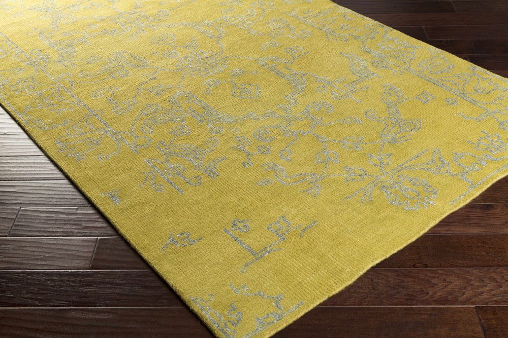 Yellow wool rug corner with light geometric pattern and woven texture