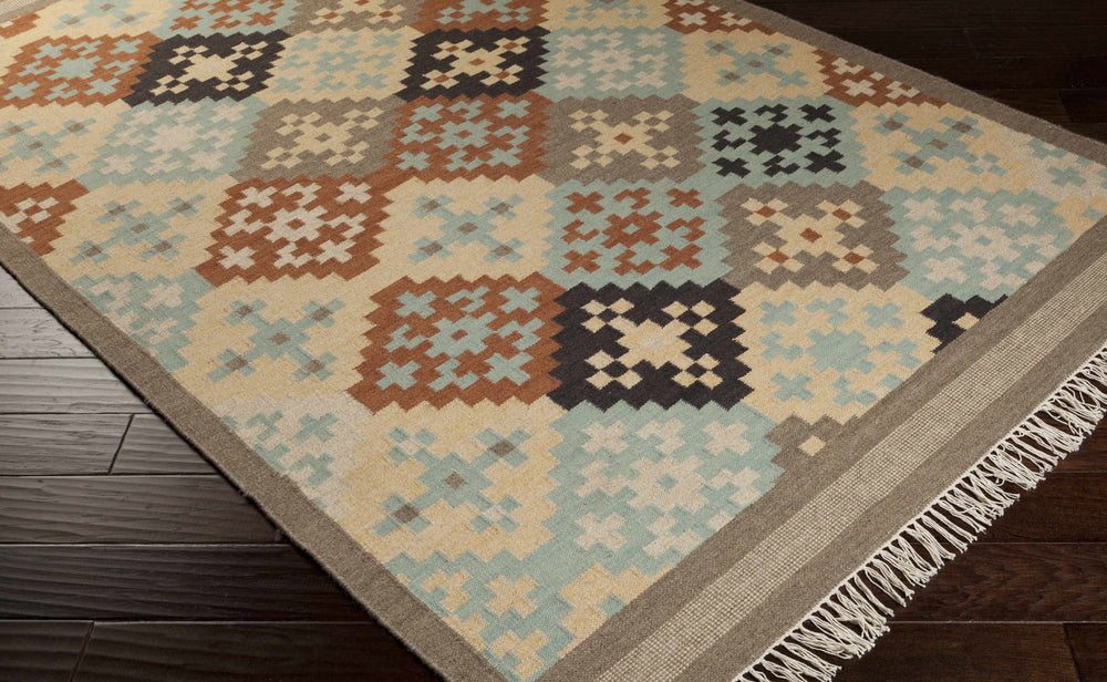 Geometric hand-woven wool rug with beige border, blue field, orange and black motifs; fringe.