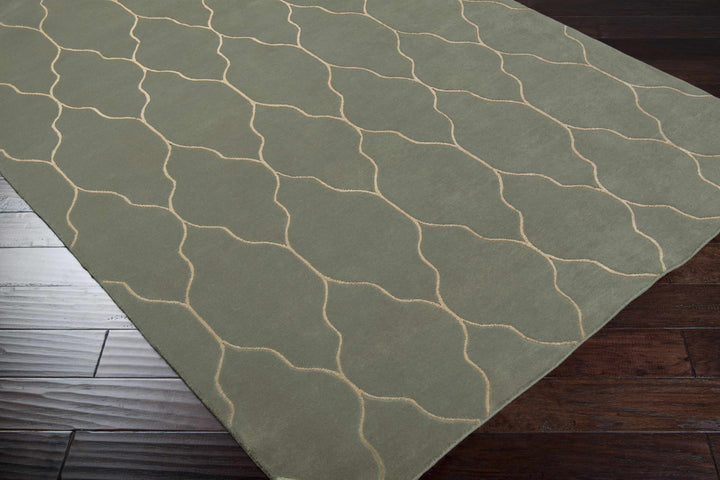 Gray area rug with light trellis geometric pattern, corner angle view on floor